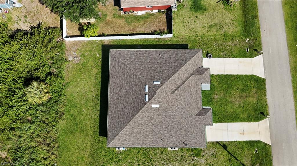4816 24th Street Southwest Lehigh Acres, FL 33973 - Photo 27 of 32 an aerial view of a house with a yard
