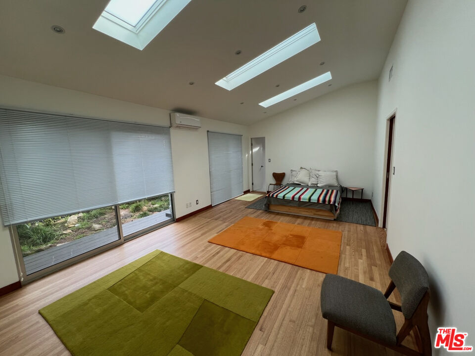 254 Tranquillo Road Pacific Palisades, CA 90272 - Photo 11 of 16 a living room with a rug