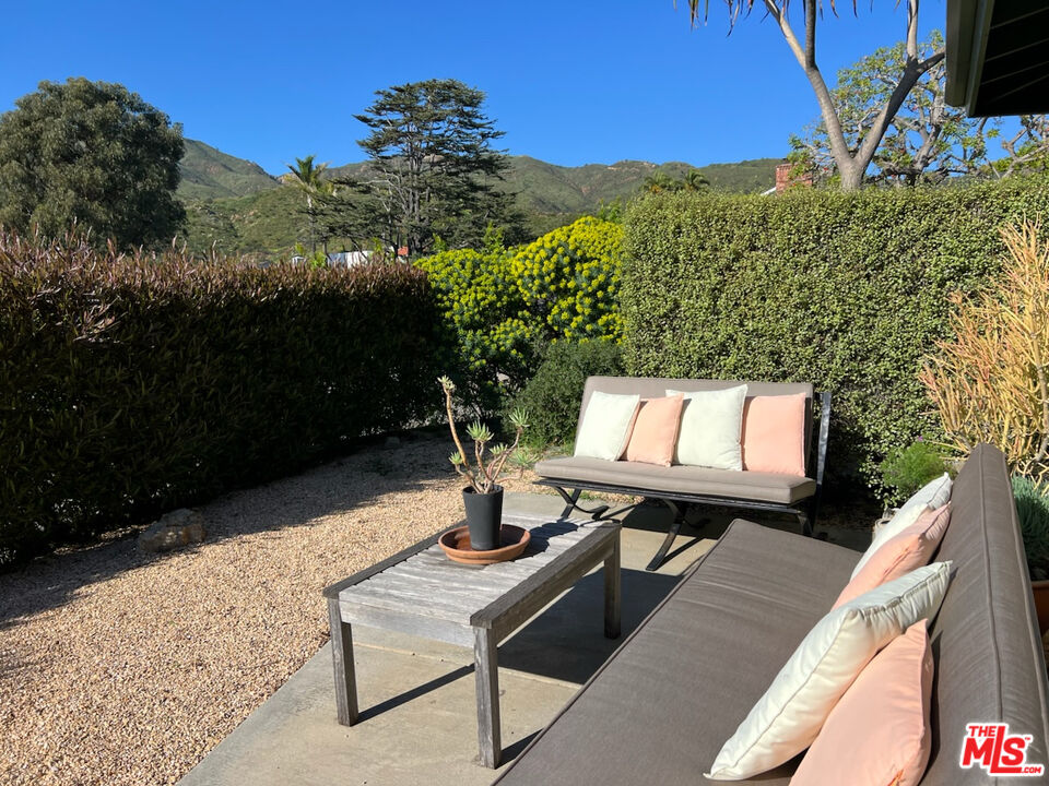 254 Tranquillo Road Pacific Palisades, CA 90272 - Photo 14 of 16 a view of a balcony with chairs and a potted plant