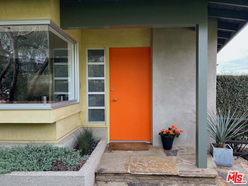 254 Tranquillo Road Pacific Palisades, CA 90272 - Photo 3 of 16 a view of potted plants in front of a door