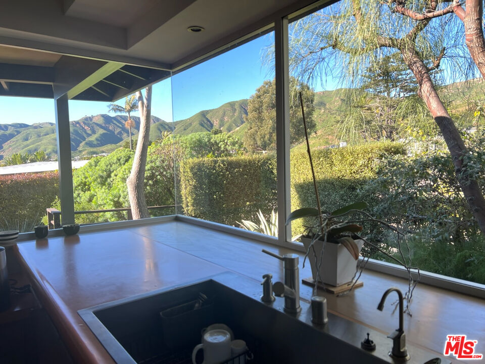 254 Tranquillo Road Pacific Palisades, CA 90272 - Photo 4 of 16 a view of a floor to ceiling window in an outdoor space