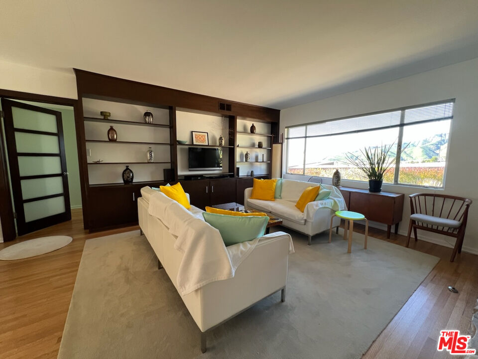 254 Tranquillo Road Pacific Palisades, CA 90272 - Photo 5 of 16 a living room with furniture and a large window