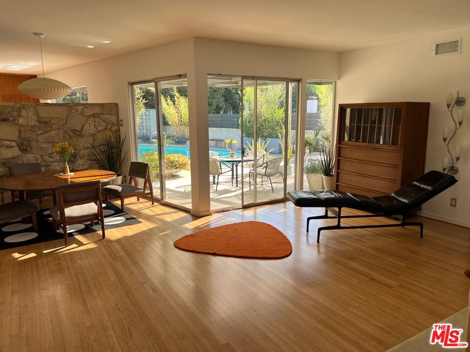 254 Tranquillo Road Pacific Palisades, CA 90272 - Photo 6 of 16 a living room with furniture pool table and glass door