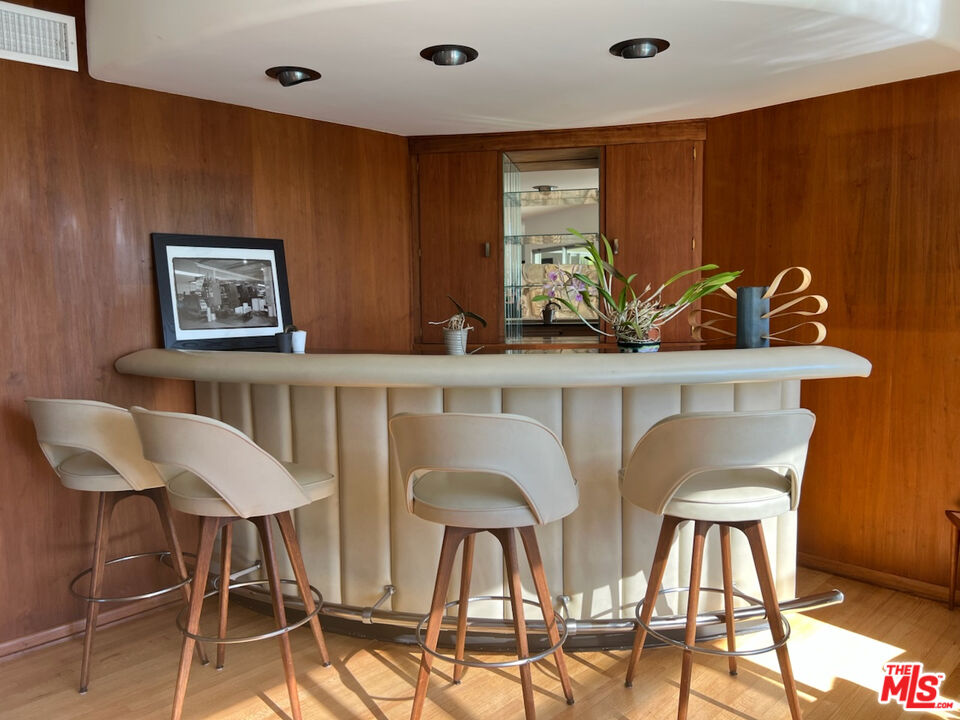 254 Tranquillo Road Pacific Palisades, CA 90272 - Photo 7 of 16 a view of a dining room with furniture and chandelier