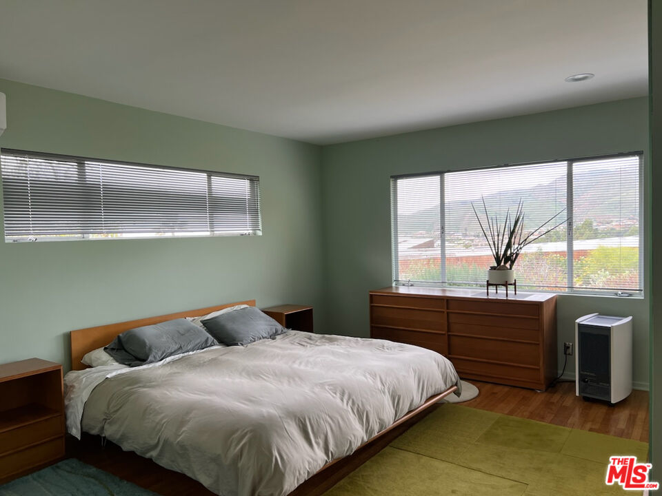 254 Tranquillo Road Pacific Palisades, CA 90272 - Photo 8 of 16 a bedroom with a bed and a large window