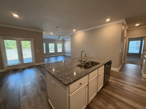 a kitchen with sink stove and refrigerator