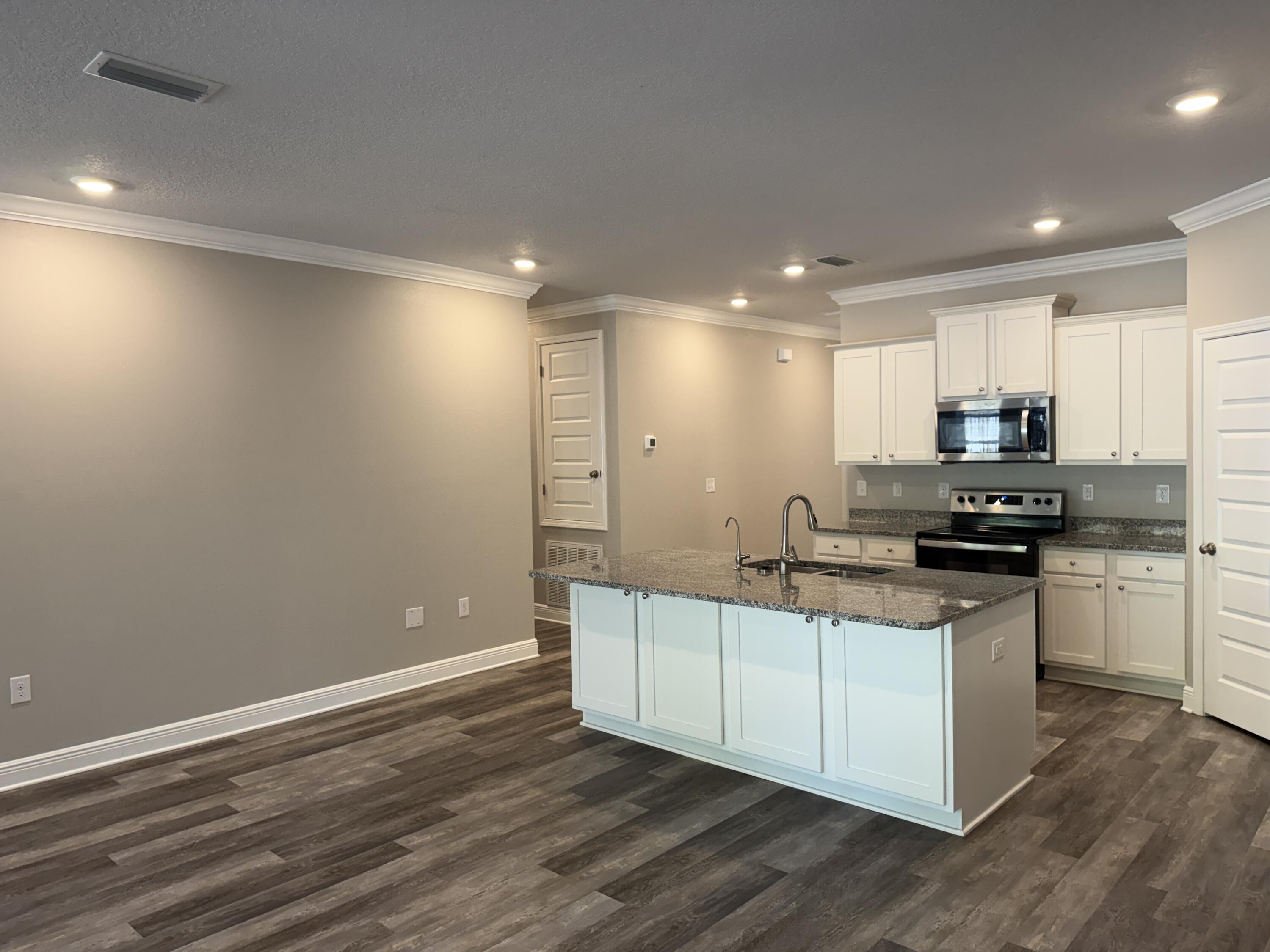 491 Lightning Bug Lane, Unit LOT 11 Freeport, FL 32439 - Photo 17 of 34 a kitchen with stainless steel appliances a refrigerator and a stove top oven