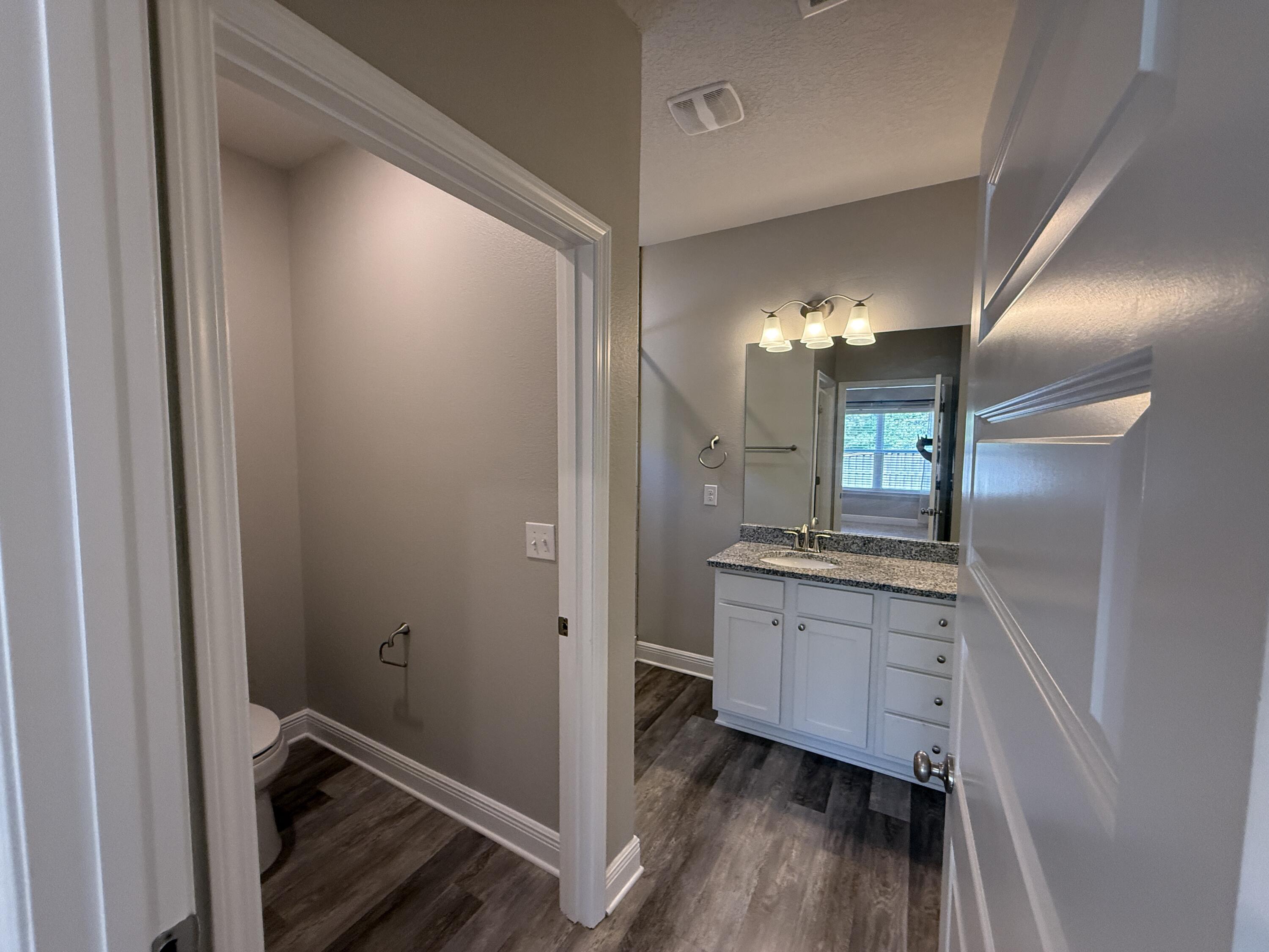 491 Lightning Bug Lane, Unit LOT 11 Freeport, FL 32439 - Photo 26 of 34 a bathroom with a double vanity sink and a mirror