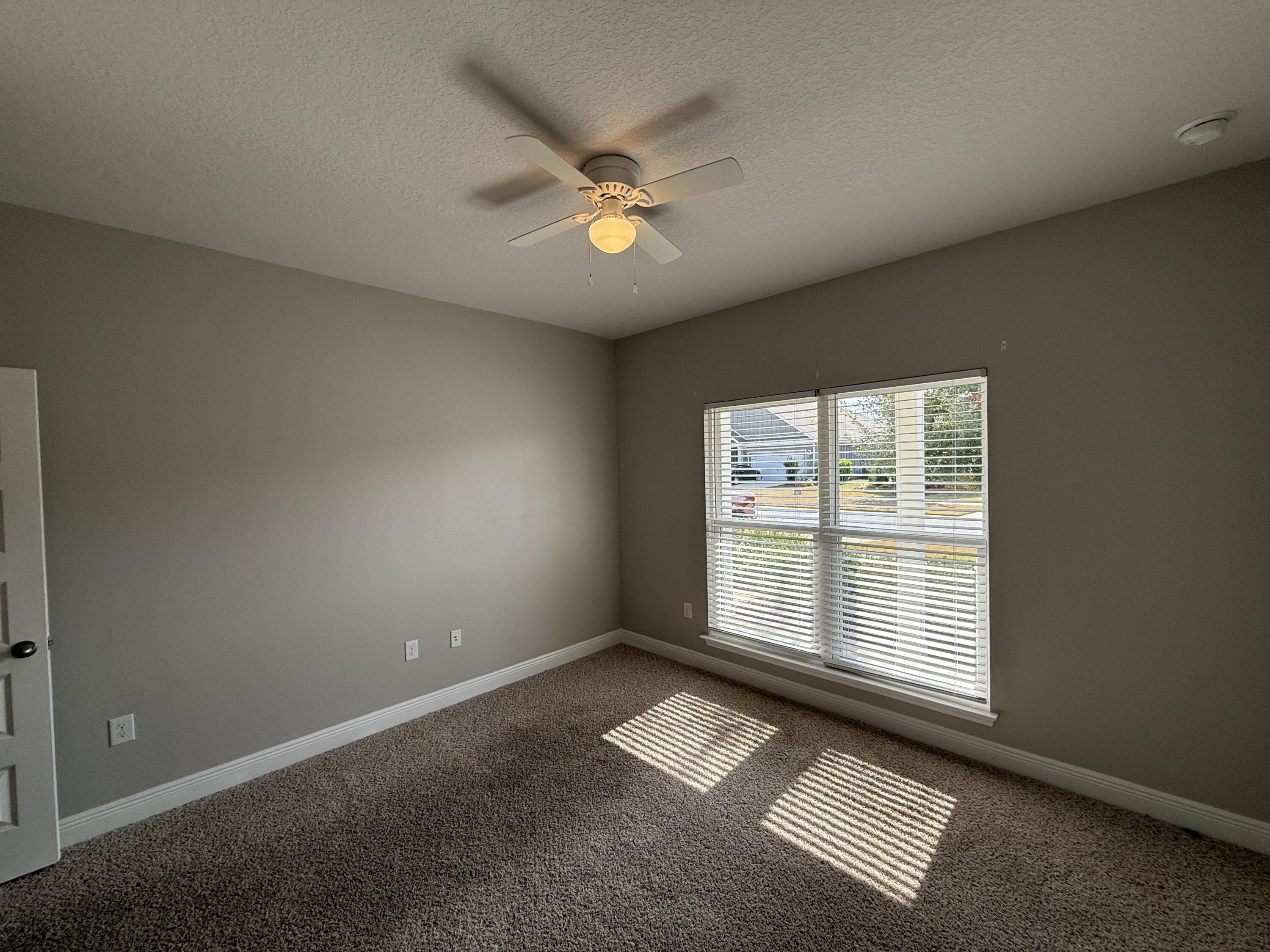 491 Lightning Bug Lane, Unit LOT 11 Freeport, FL 32439 - Photo 5 of 34 an empty room with windows and fan
