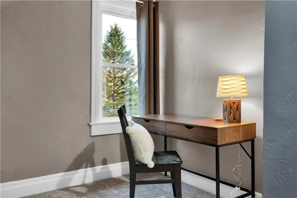 a view of a livingroom with furniture and window