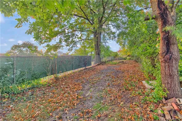 a view of a house with a tree in a yard