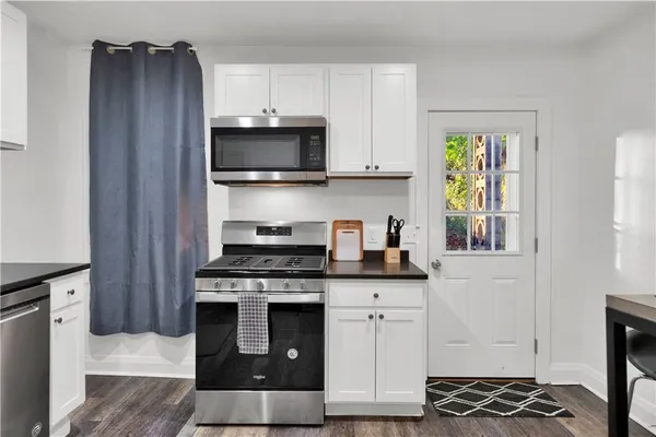 a kitchen with stainless steel appliances granite countertop a stove and a refrigerator