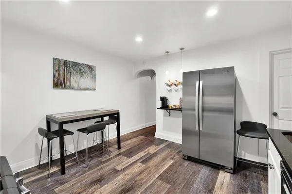 a kitchen with a refrigerator and a sink