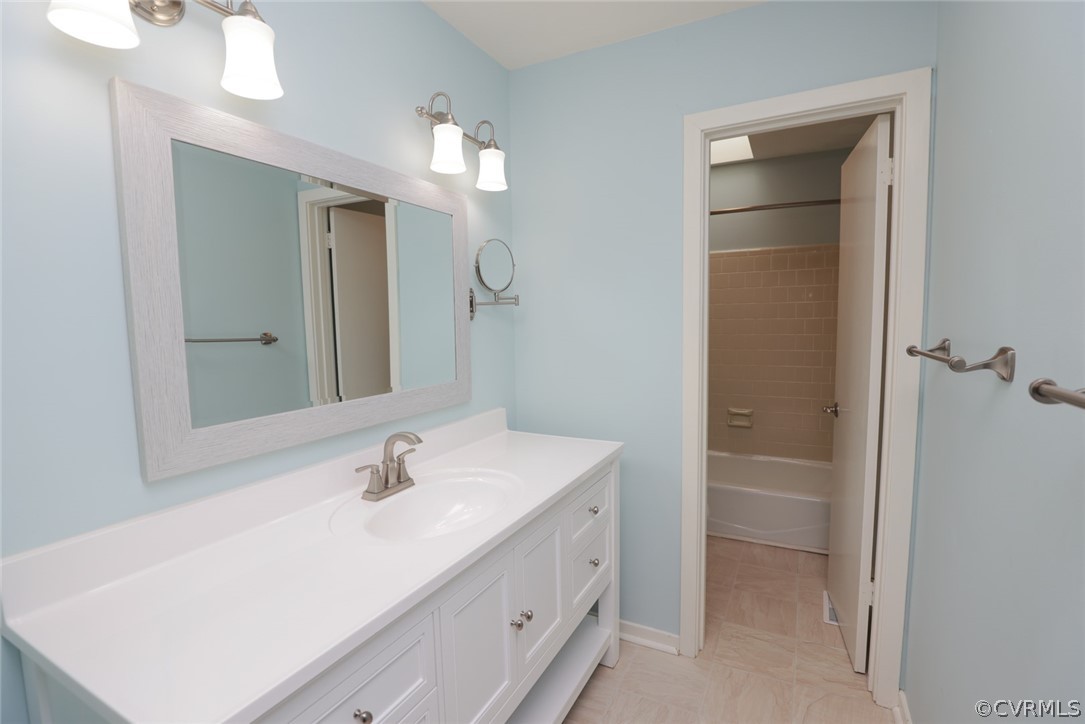 3024 3 Bridges Road Midlothian, VA 23112 - Photo 24 of 50 a bathroom with a sink a light fixture a vanity and a mirror