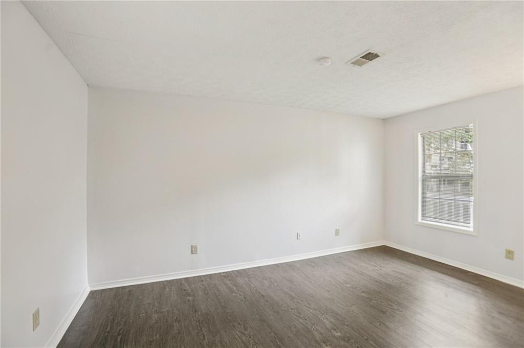 801 Countryside Place Smyrna, GA 30080 - Photo 13 of 34 an empty room with wooden floor and windows