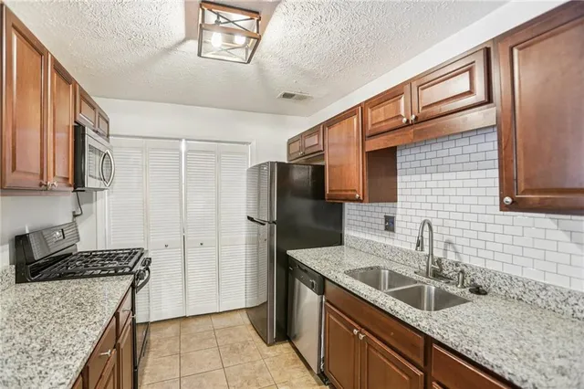 a bathroom with a shower sink and mirror