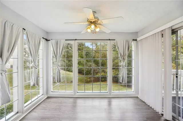 wooden floor fireplace and windows in an empty room