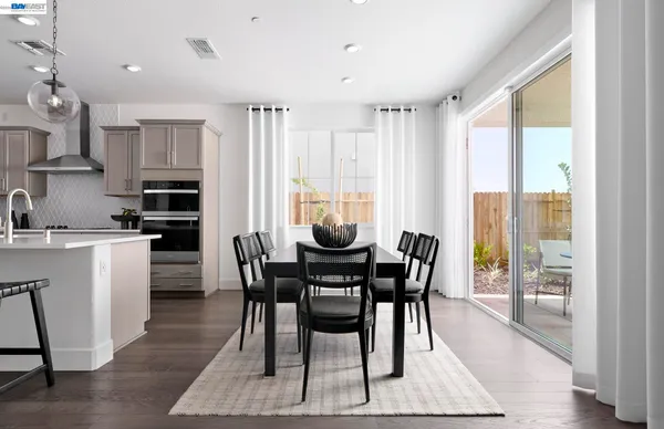 a view of a dining room with furniture and a window