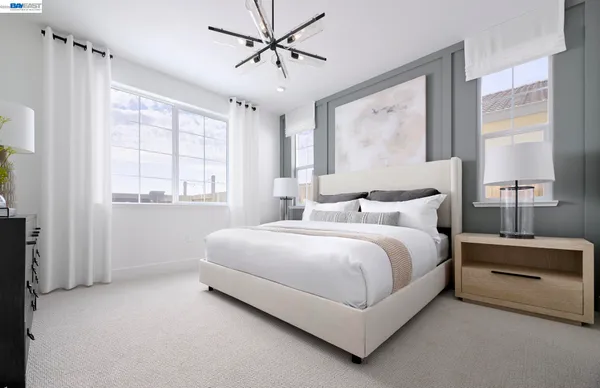 a bedroom with a large bed and a window