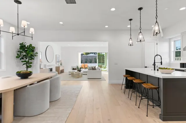 a kitchen with stainless steel appliances a sink a counter space and a dining table