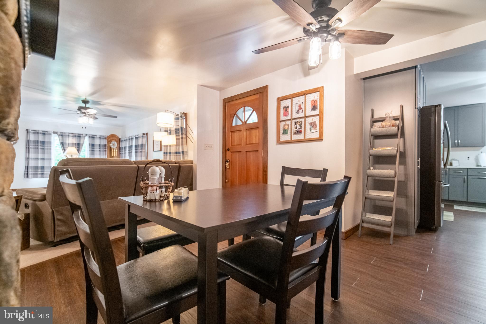 13127 Manor Furnace Road Brogue, PA 17309 - Photo 35 of 78 a dining room with furniture a chandelier and wooden floor
