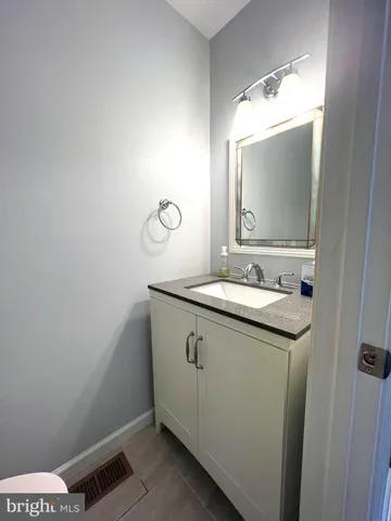 a white toilet sitting next to a sink