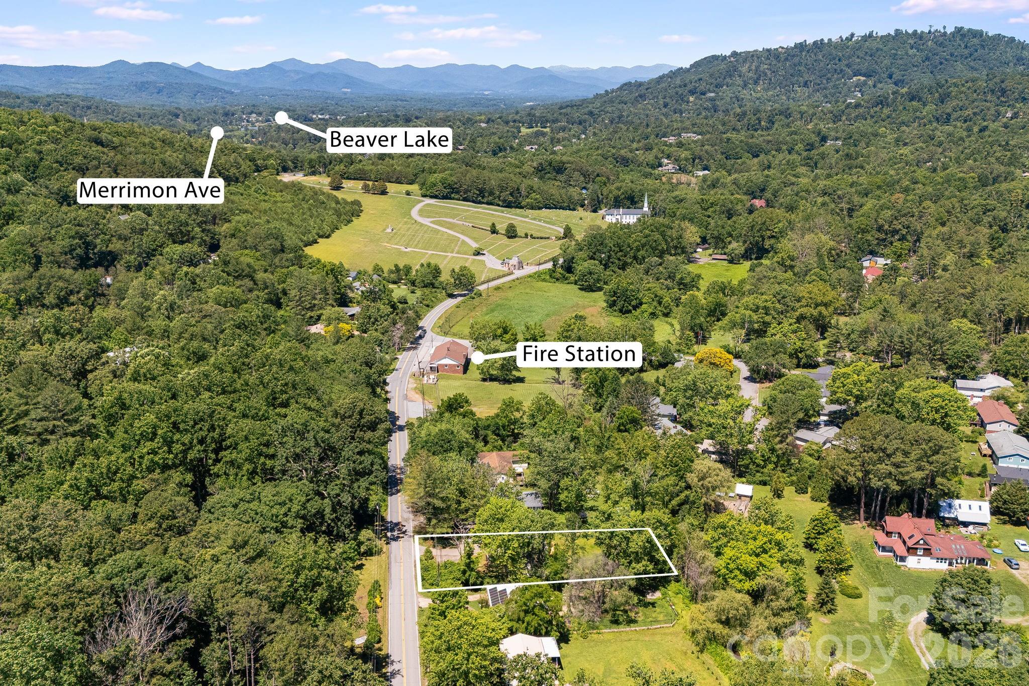 468 Beaverdam Road Asheville, NC 28804 - Photo 6 of 19 a view of a city with lush green forest