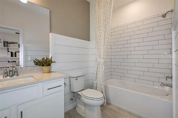 a bathroom with a sink a toilet and bathtub