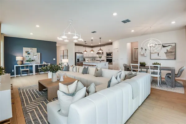 a living room with furniture and a chandelier