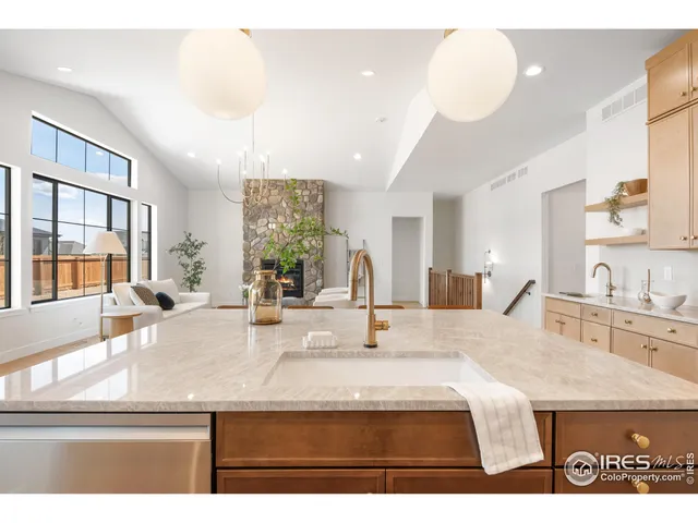 a view of living room with kitchen island furniture and large windows