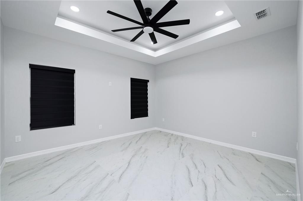 210 Bernie Rio Grande City, TX 78582 - Photo 11 of 20 an empty room with a window and a ceiling fan