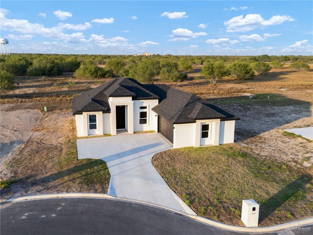 210 Bernie Rio Grande City, TX 78582 - Photo 2 of 20 a view of a white house with a outdoor space