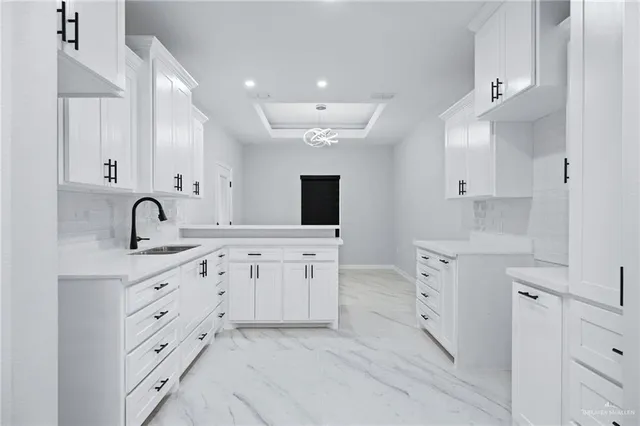 a kitchen with cabinets appliances and a sink