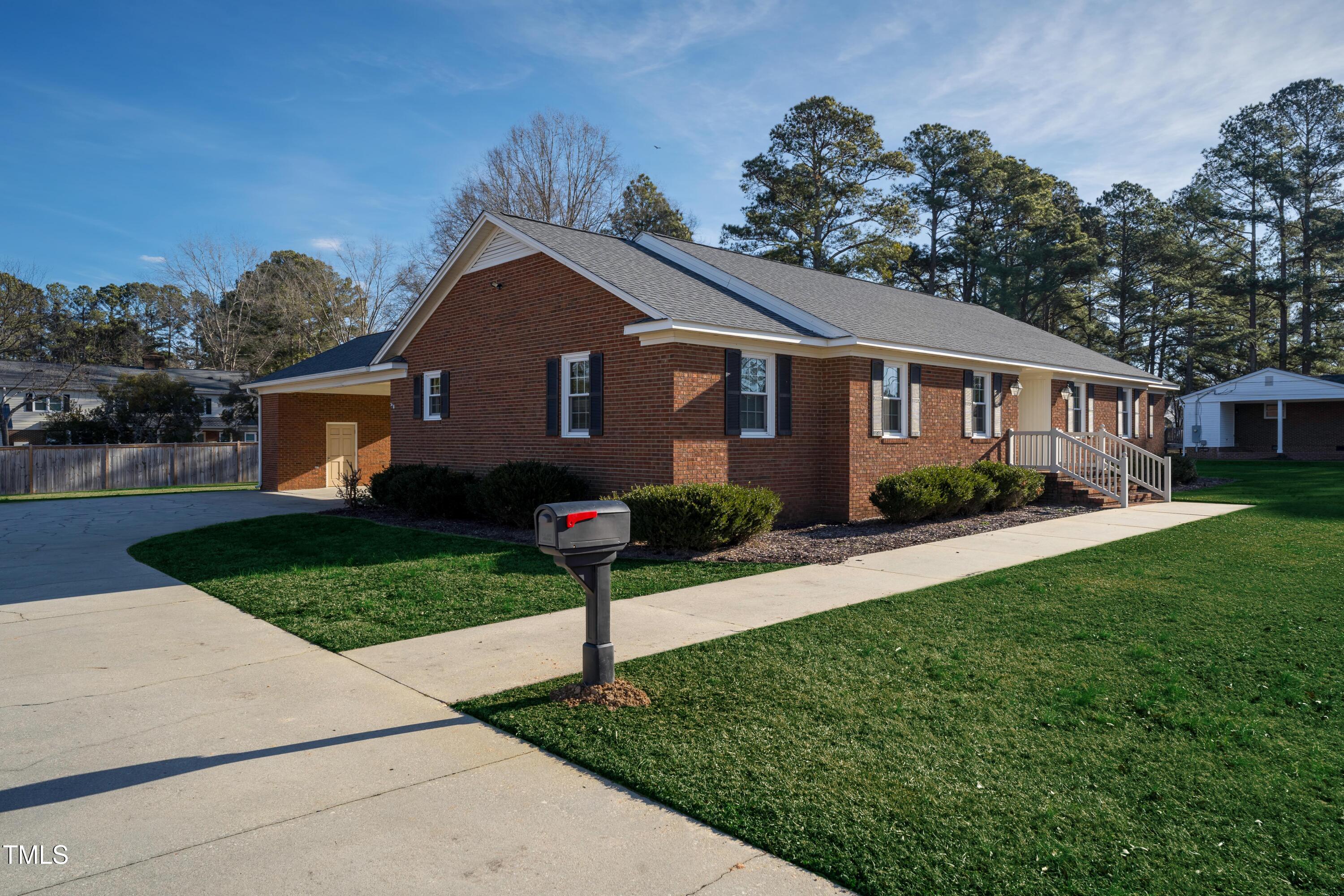 610 Denim Drive Erwin, NC 28339 - Photo 2 of 49 a front view of a house with a yard and trees