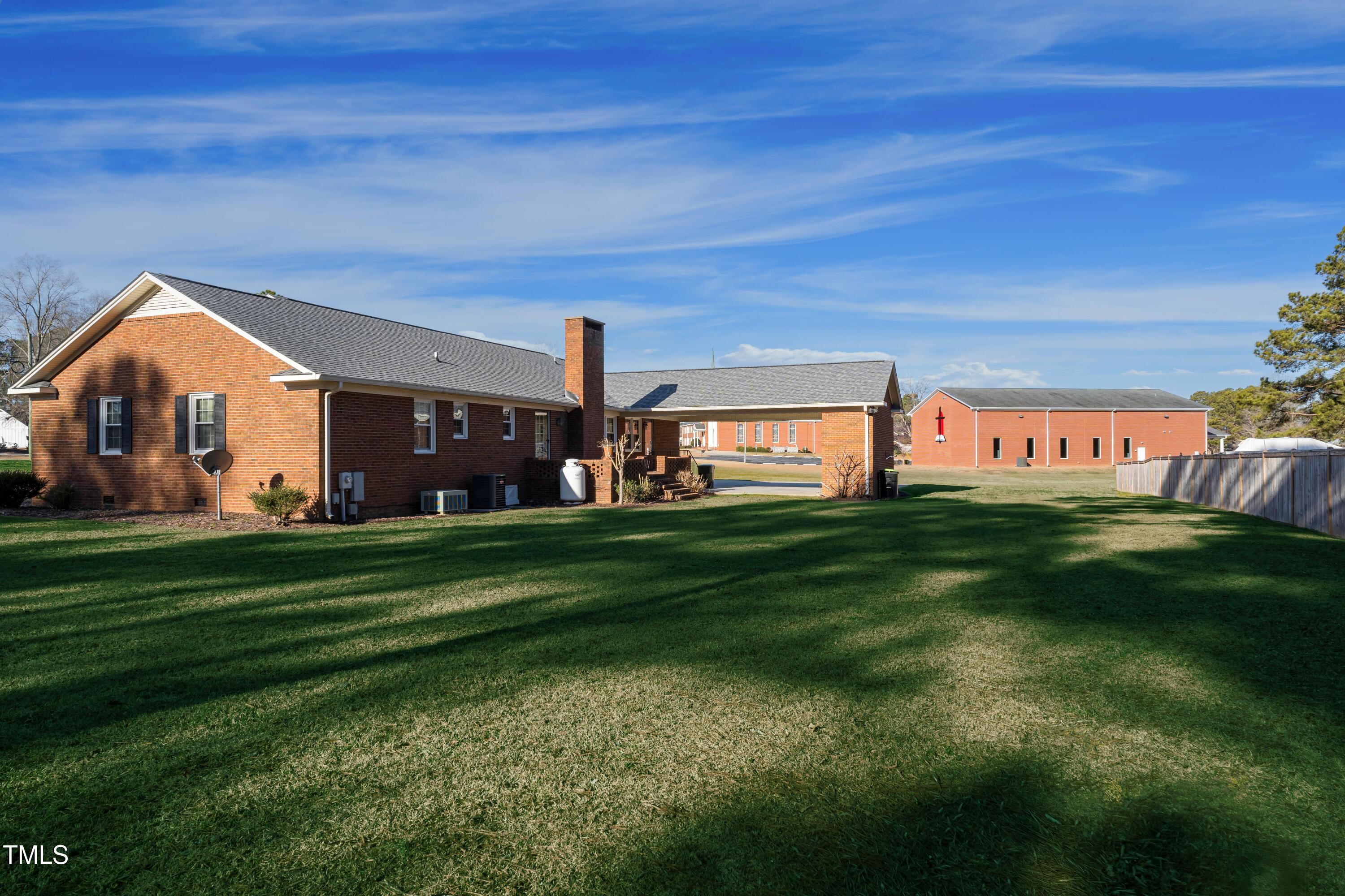 610 Denim Drive Erwin, NC 28339 - Photo 3 of 49 a front view of a house with a garden