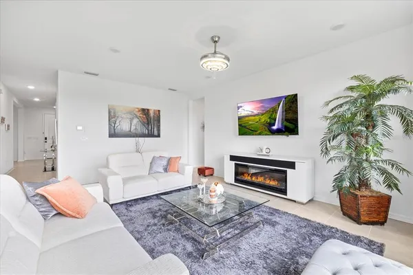 a living room with furniture a fireplace and a flat screen tv