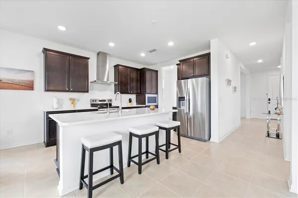 a kitchen with stainless steel appliances a refrigerator stove microwave and cabinets