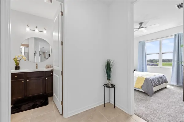 a bedroom with a bed and a potted plant