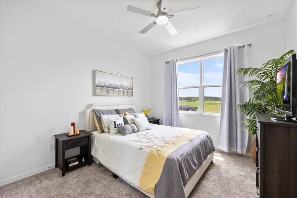 a bedroom with a bed and a painting on the wall