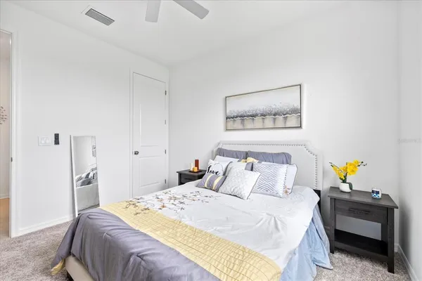 a bathroom with a granite countertop toilet sink and mirror