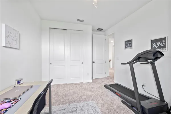 a spacious bedroom with a bed and a table with chair