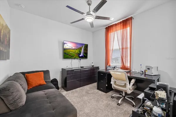 a living room with furniture and a book shelf