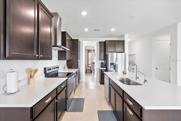 a kitchen with stainless steel appliances a sink stove and refrigerator