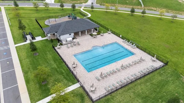 an aerial view of residential houses with outdoor space and lake view