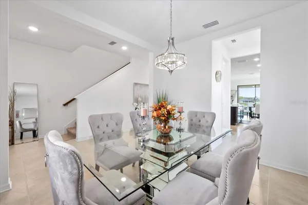 a view of a dining room with furniture and chandelier