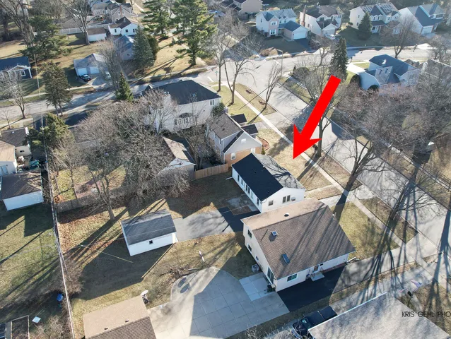 an aerial view of residential house with outdoor space and parking