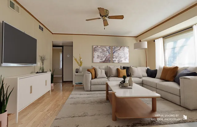a view of empty room with wooden floor and fan