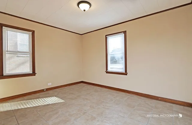 an empty room with windows and closet