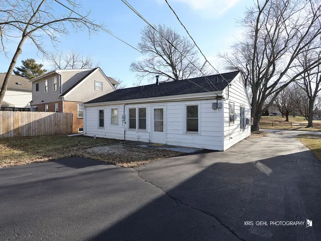 a view of a house with a yard covered in snow
