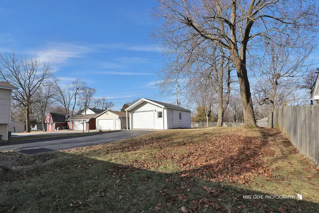 a view of a yard with large trees